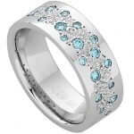A Random Set Diamond Dress Ring With Light Aqua Blue Diamonds C915 adorned with a stunning aqua blue topaz.
