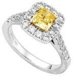 A Fancy Intense Yellow cushion cut halo diamond ring with a halo of diamonds.