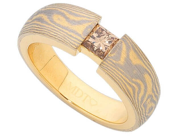 A Mokume Gane Ring With Princess Cut Champagne Diamond C1257 with a 18ct yellow gold and white gold band.