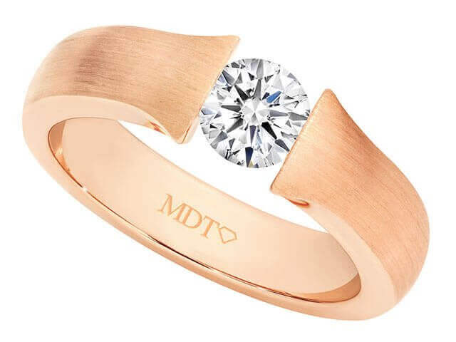 A rose gold tension set diamond ring C854 with an oval cut diamond.