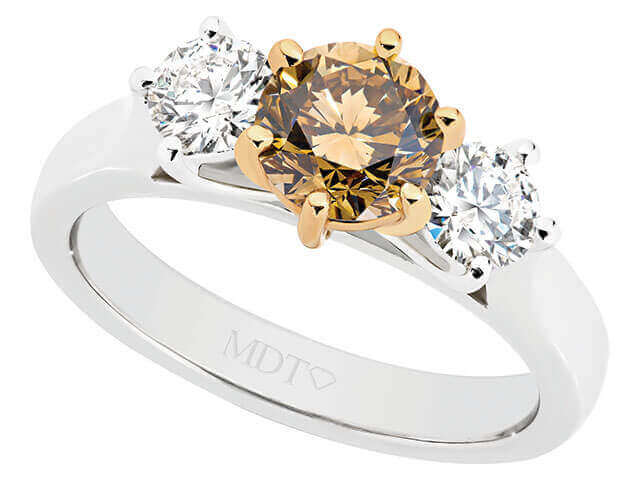 A Trilogy champagne diamond engagement ring C917 featuring three champagne diamonds set in white and yellow gold.