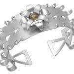A silver cuff ring with a flower on it that won the Dangerous Game -2010 Award Winner -C4037 in 2010.