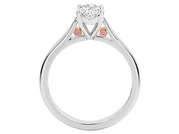 A Oval White and Pink diamond engagement ring C1065 adorned with bezel set pink diamonds from Argyle, featuring an elegant oval-shaped diamond in the centre