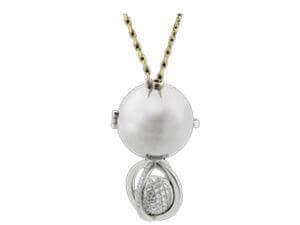 A pendant with a Soiree -2006 Award Winner and diamonds on a chain, perfect for a Soiree or as an elegant 2006 Award Winner accessory.