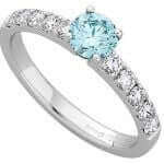 A Blue Round Diamond centre with white Diamonds claw set on the Band C666 18ct white gold
