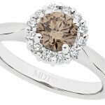 An round claw-set Claw set champagne diamond halo engagement ring in white gold.