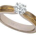 A 6 Claw Diamond Mokume Gane engagement ring featuring a diamond at its center.