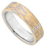 A Mokume Gane ring with grain set white diamonds in yellow gold and white gold.