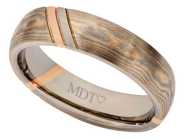 This 18ct rose and 18ct white gold Mokume Gane Wedding Ring C727 features a stunning rose gold inlay, making it a perfect choice for those seeking a unique Mokume Gane wedding ring.