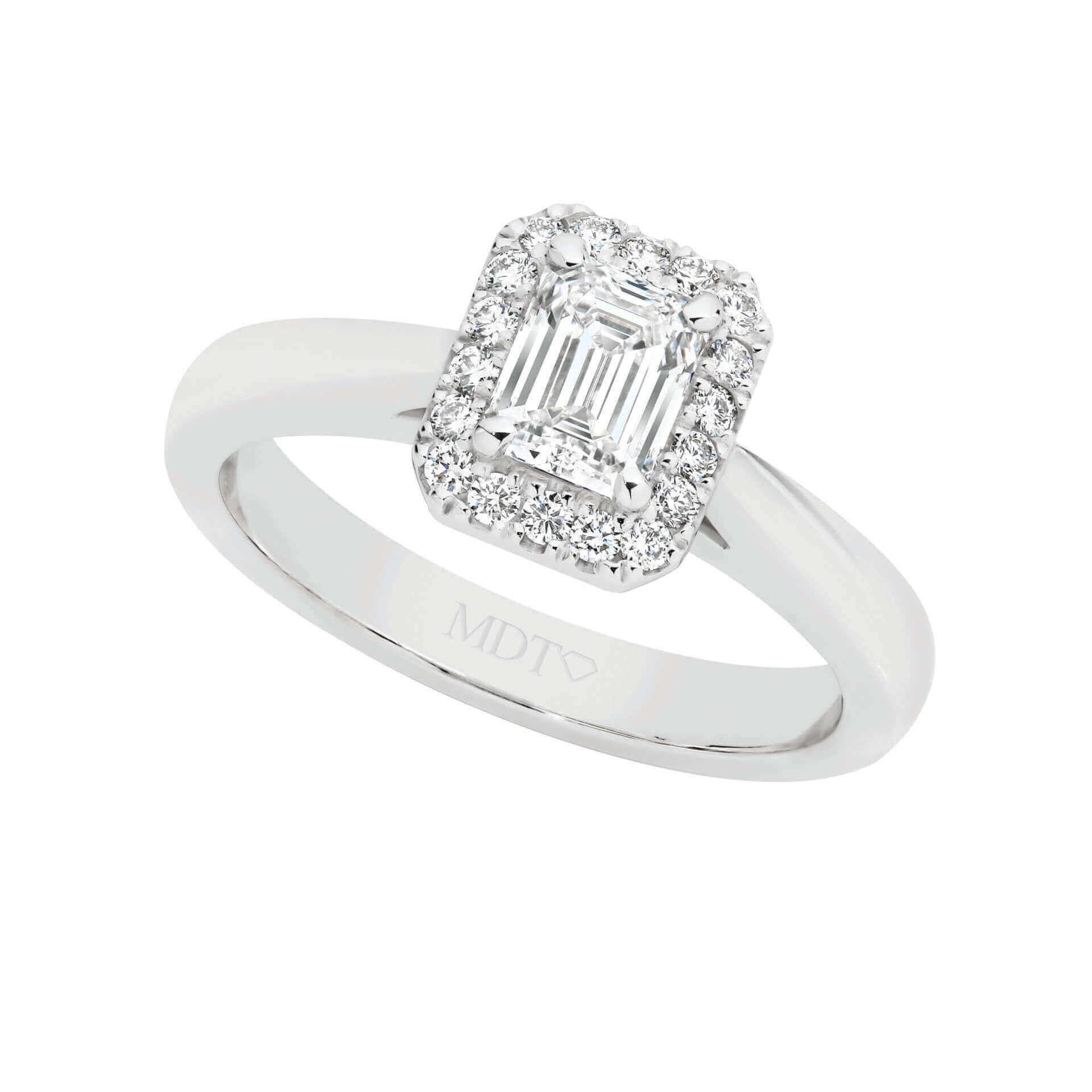 An Emerald Cut Diamond Halo Engagement Ring C1067 is a stunning piece of jewelry that elegantly combines the brilliance of an emerald cut diamond with the enchanting beauty of a halo setting. This exquisite ring is