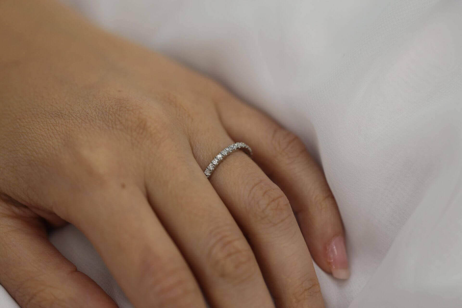A woman's hand adorned with a magnificent White gold claw set diamond wedding ring C571.