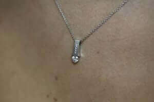 A close up of an Emery C1006 tension set diamond necklace.