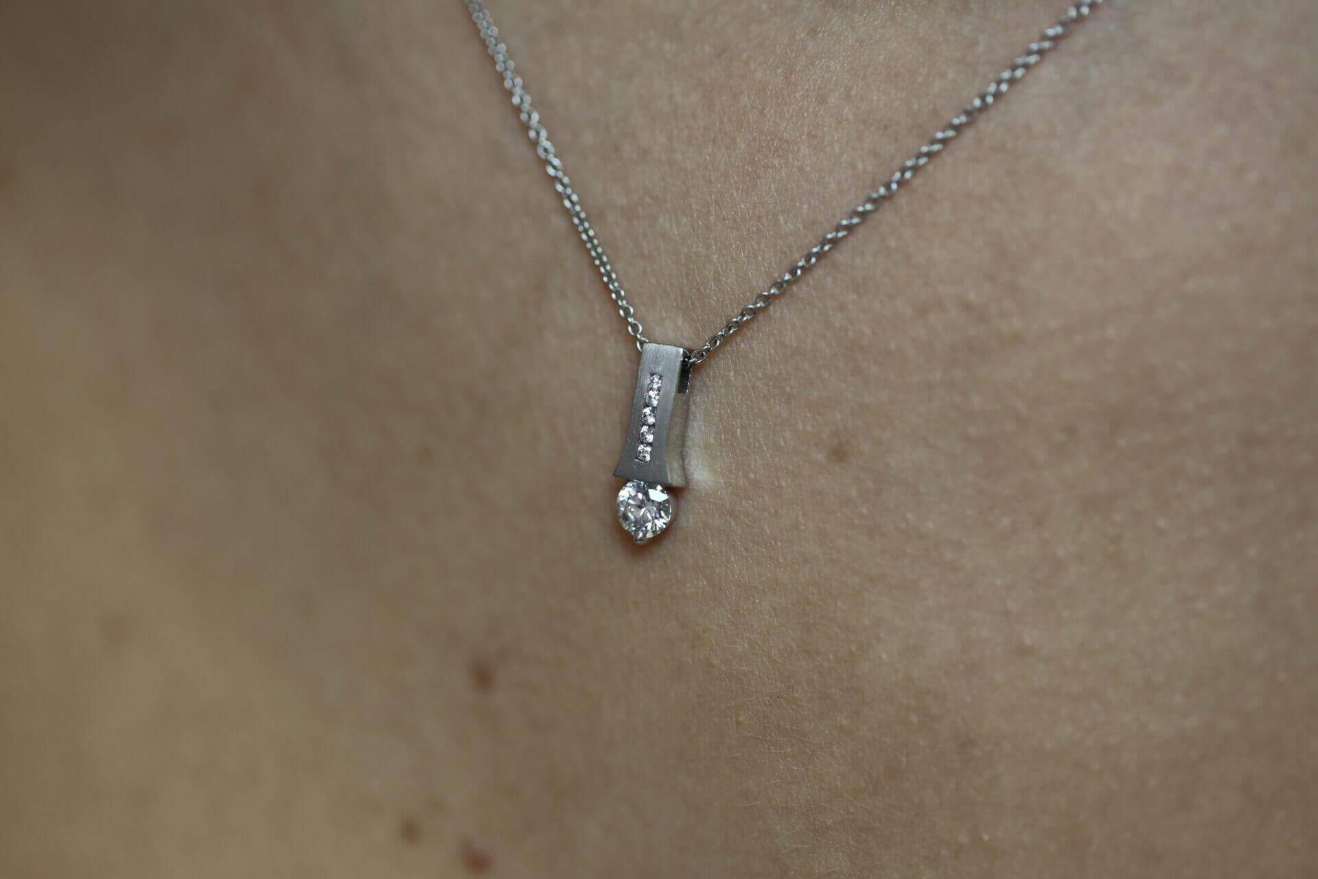 A close up of an Emery C1006 tension set diamond necklace.
