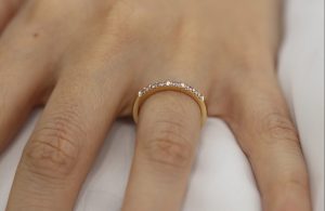 A woman's hand with a Rose Gold Pink Diamond Wedding Ring C572-Pink.