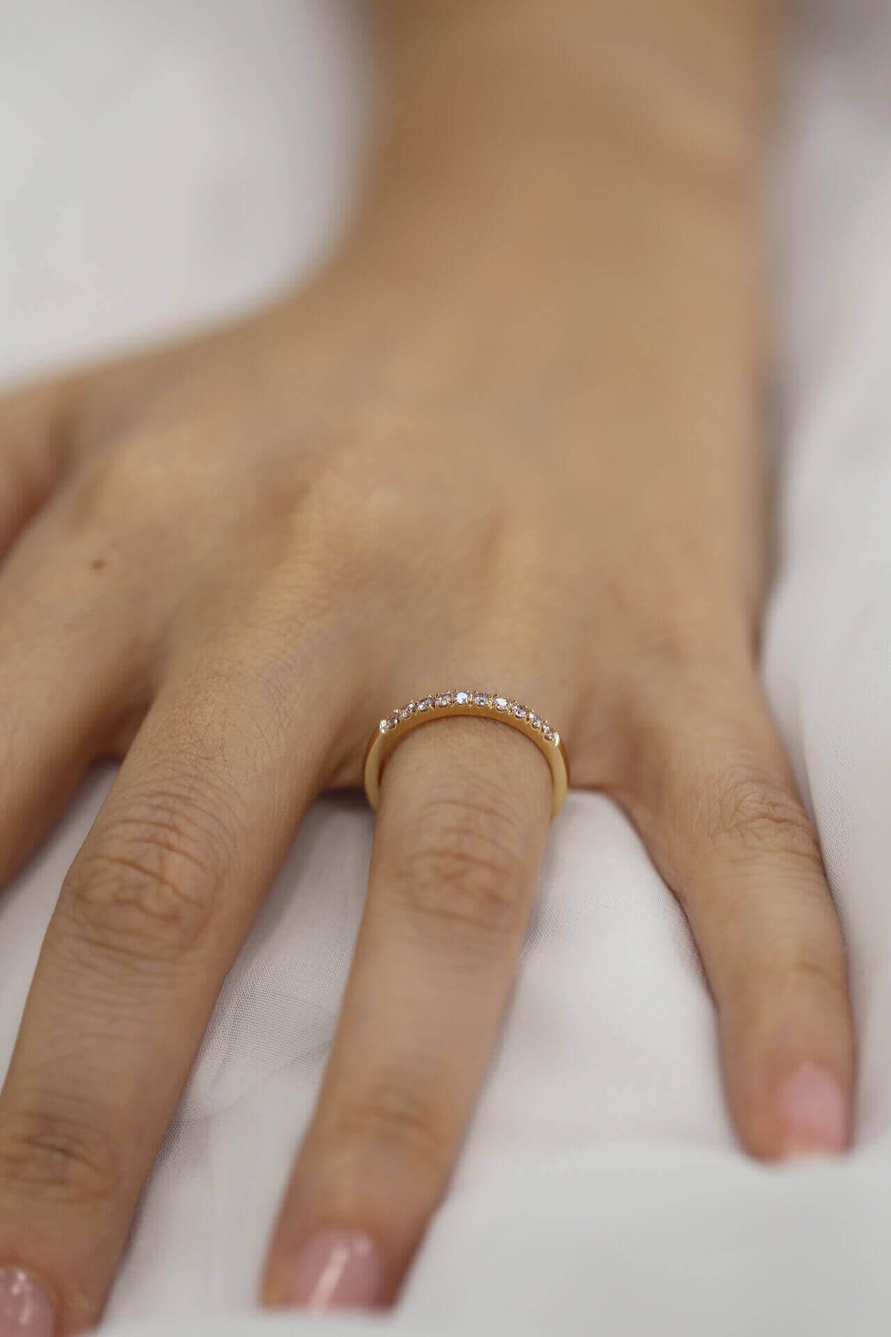 A woman's hand with a Rose Gold Pink Diamond Wedding Ring C572-Pink.