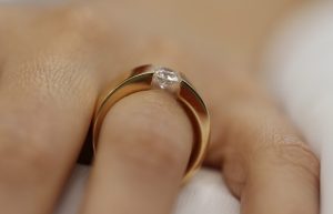 A woman's hand with a Rose Gold Tension Set Ring C364.