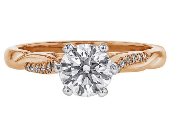 A rose gold engagement ring featuring an oval cut diamond.