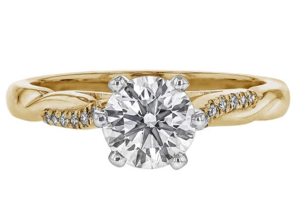 A yellow gold engagement ring adorned with a round brilliant cut diamond.