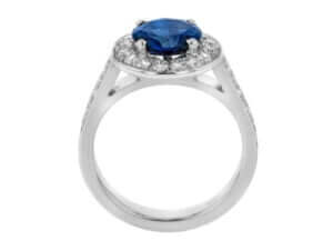 This Australian Blue Sapphire and Diamond Halo Engagement Ring C1206 features a stunning blue sapphire surrounded by dazzling white diamonds in 18ct white gold