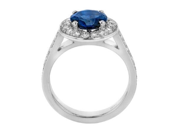 This Australian Blue Sapphire and Diamond Halo Engagement Ring C1206 features a stunning blue sapphire surrounded by dazzling white diamonds in 18ct white gold