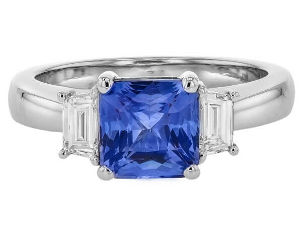 A Blue Sapphire Trilogy Engagement Ring C760 featuring an emerald cut tanzanite and diamond.