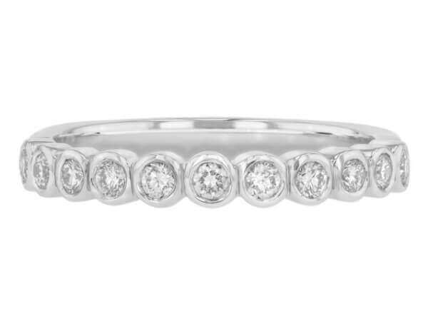 18ct white gold wedding band adorned with bezel-set round diamonds. Top view