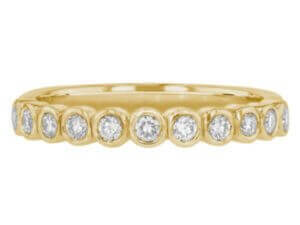 18ct yellow gold wedding band adorned with bezel-set round diamonds. Top view