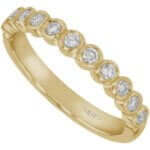 18ct yellow gold wedding band adorned with bezel-set round diamonds.