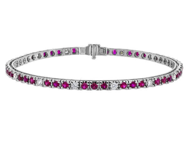 An 18k white gold Claw Set Ruby and Diamond Tennis Bracelet C926. This exquisite bracelet features claw-set rubies and diamonds, creating a dazzling display of elegance.