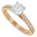 A 1.00ct cushion cut diamond engagement ring in rose gold featuring a diamond band.