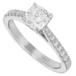A cushion cut diamond engagement ring in white gold with a diamond band.