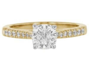 An elegant engagement ring featuring a stunning cushion cut diamond set in radiant yellow gold.