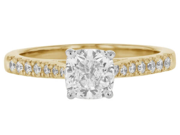 An elegant engagement ring featuring a stunning cushion cut diamond set in radiant yellow gold.