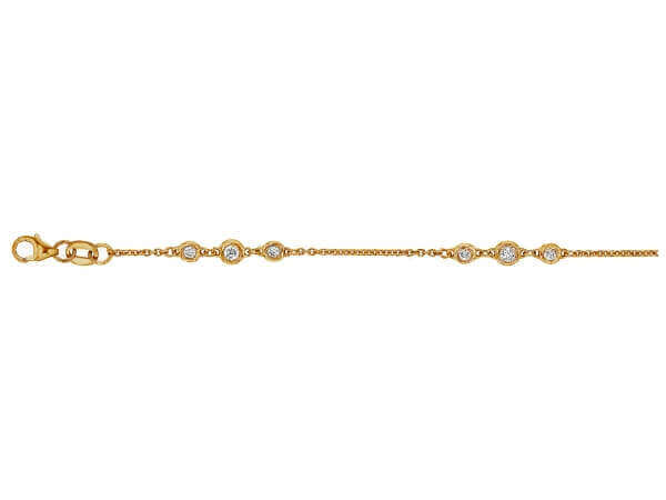 A bezel set yellow gold bracelet with .05ct and .025ct diamonds.