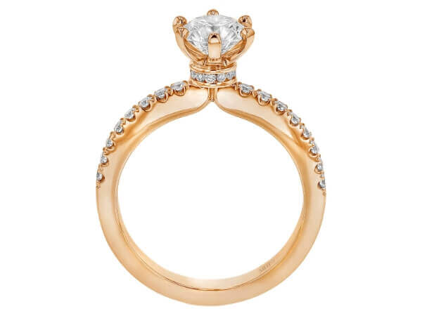 A stunning rose gold engagement ring featuring a diamond set in the center.