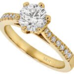 A stunning diamond engagement ring in yellow gold with a hidden halo setting.