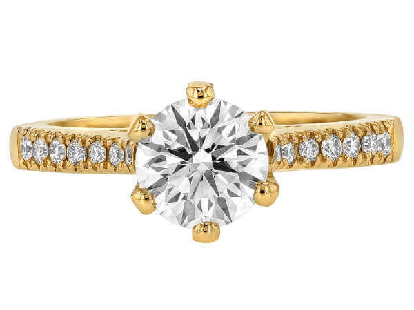 An oval diamond engagement ring in yellow gold with a hidden halo setting.