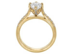 A yellow gold diamond engagement ring with an oval cut.