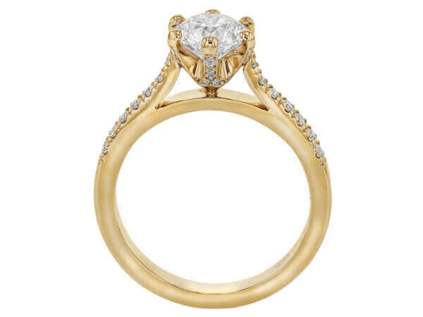 A yellow gold diamond engagement ring with an oval cut.