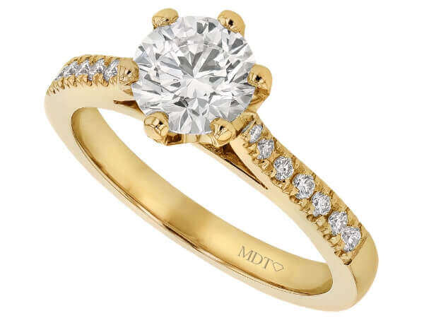 A stunning diamond engagement ring in yellow gold with a hidden halo setting.