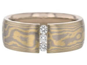 A yellow gold band with two Diamond Set Wide Mokume Gane Ring C722 accents in the center.