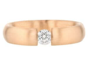 A tension set rose gold ring featuring a stunning diamond centerpiece.