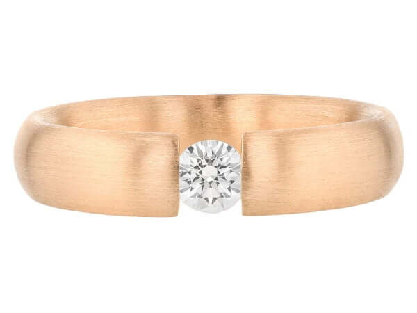 A tension set rose gold ring featuring a stunning diamond centerpiece.