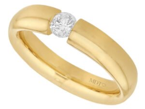 A yellow gold ring with a diamond in the center, beautifully tension set -polished finish