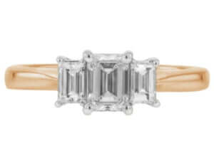 A stunning Diamond Trilogy Engagement Ring with an Emerald cut Diamond and Baguette Sides C321 featuring three emerald cut diamonds set in luxurious 18k rose gold.