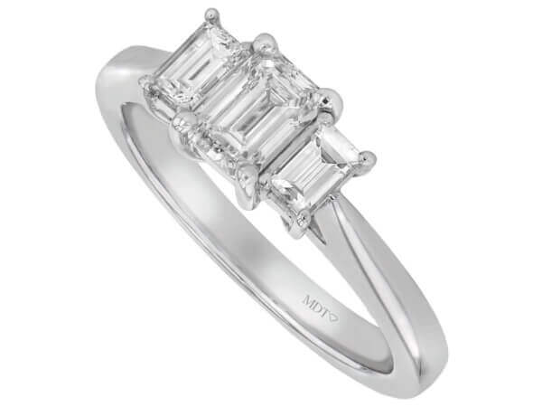 White gold Diamond Trilogy engagement ring with emerald cut diamonds.
