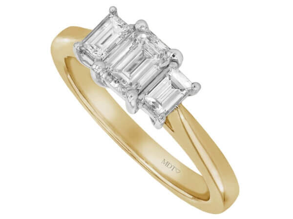 Emerald cut diamond trilogy ring in yellow gold, perfect for an engagement.