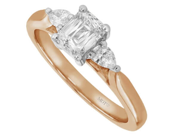 An emerald cut diamond trilogy engagement ring with pear shapes in rose gold c1236