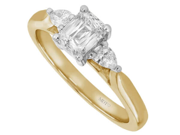 An emerald cut diamond trilogy engagement ring with pear shapes in yellow gold c1236