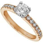 A rose gold engagement ring featuring a stunning four claw set diamond and claw set small diamonds in the band